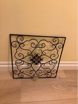 wall sconce features a black scroll design