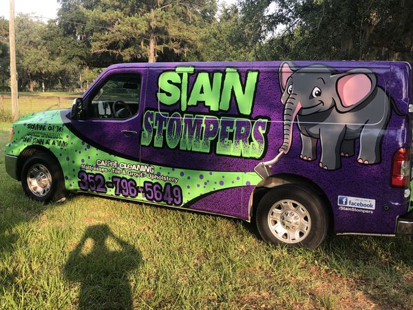 A white van with a truck-mounted carpet cleaning machine