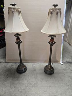 Pair of lamps with amber colored stones and palm leaf highlights.