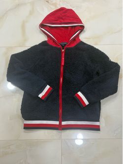 Tommy Hilfiger navy blue faux fur hoodie with red accents and striped cuffs.