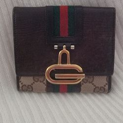 Sherry Line GG Canvas Wallet. It is a vintage, double-sided design that features a combination