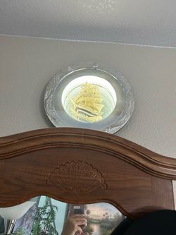 A wall mirror with light up ship