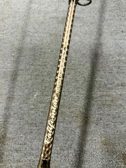Salt water fishing rod with black guide rings, black wrapping accents, and a textured handle. 7'6" spinning Rod 15-40lbs