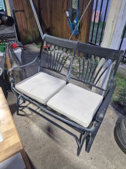Nice Used cast iron aluminum two Seater glider.  With two bottom cushions.