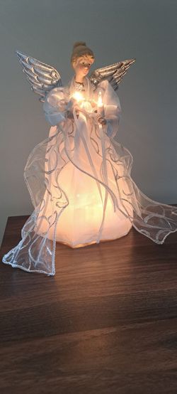 Decorative angel designed to be placed at the top of a Christmas tree or used as a tabletop decoration