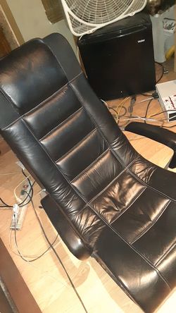 X game leather rocking chair with controls on the side speakers in the back