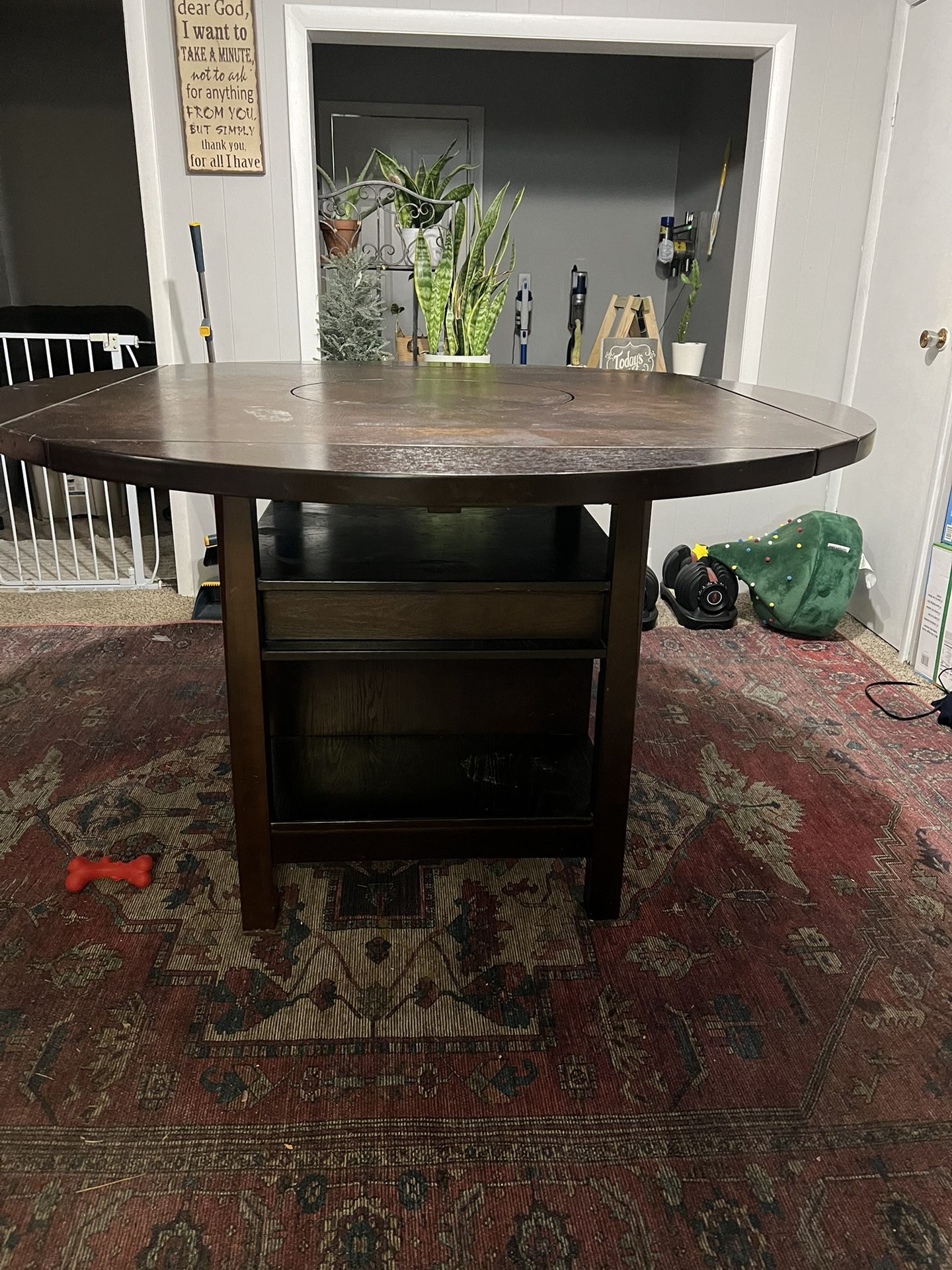 Heavy pub style table with lazy susan and 4 chairs  Very heavy has wine rack underneath has a Lazy Susan on top chairs are in good condition. There ar