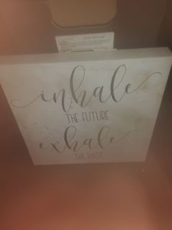 Wall sign "InhaleThe Future Exhale The Past"
