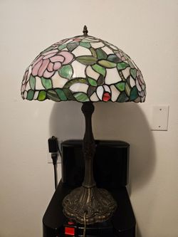 Tiffany Studios style table lamp features a dome-shaped shade with a pink rose floral pattern.StyleTiffany Studios style table lamp features a dome-sh