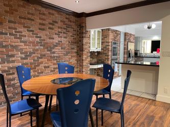 Round glass dining table plus six chairs