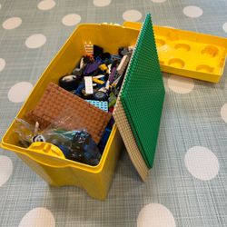 Bin of LEGO bricks and a few base plates