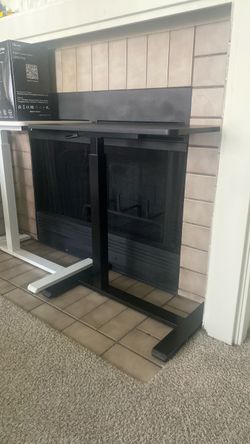 A Set of A Black and A White Electric Standing Desk Frame