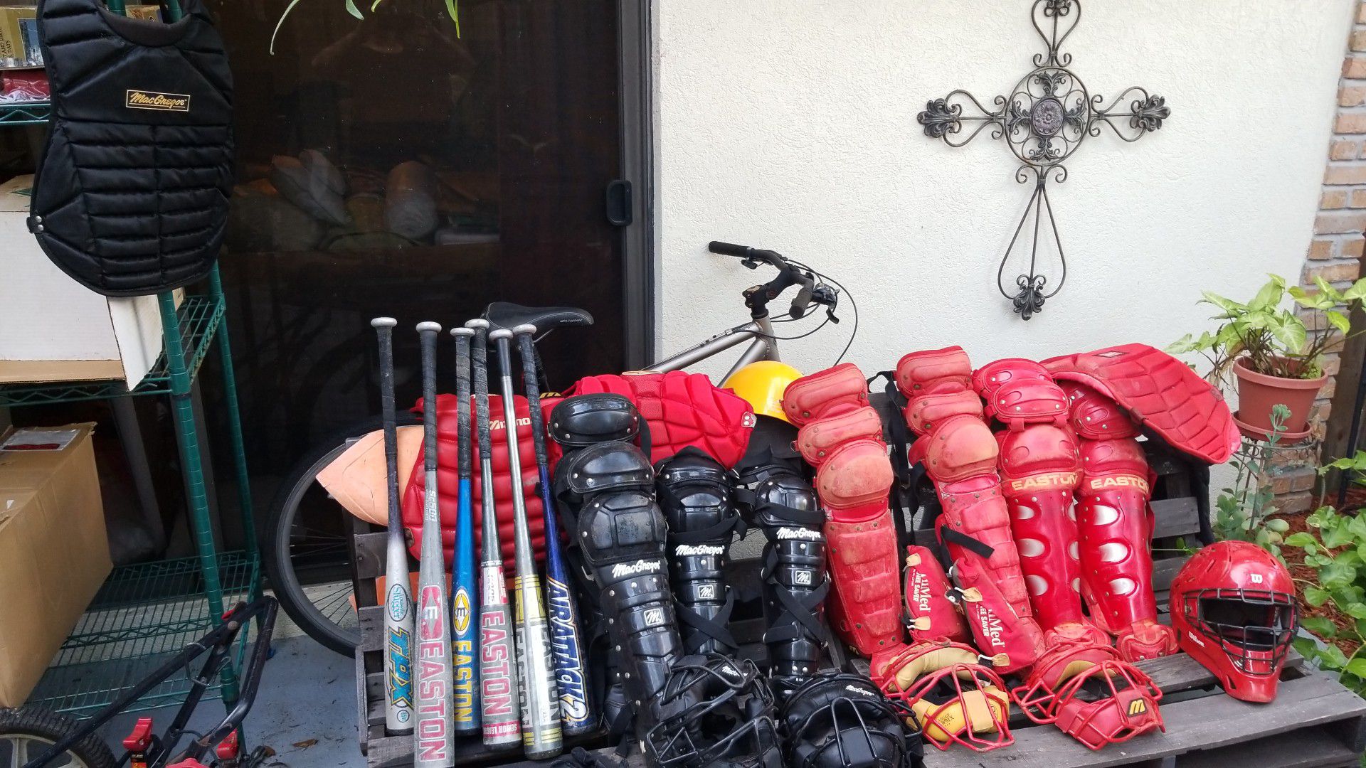 All baseball equipment..gloves, bats, 2 sets of catcher equipment adult and child in black and red