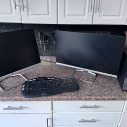 2 large computer monitors and a small desktop