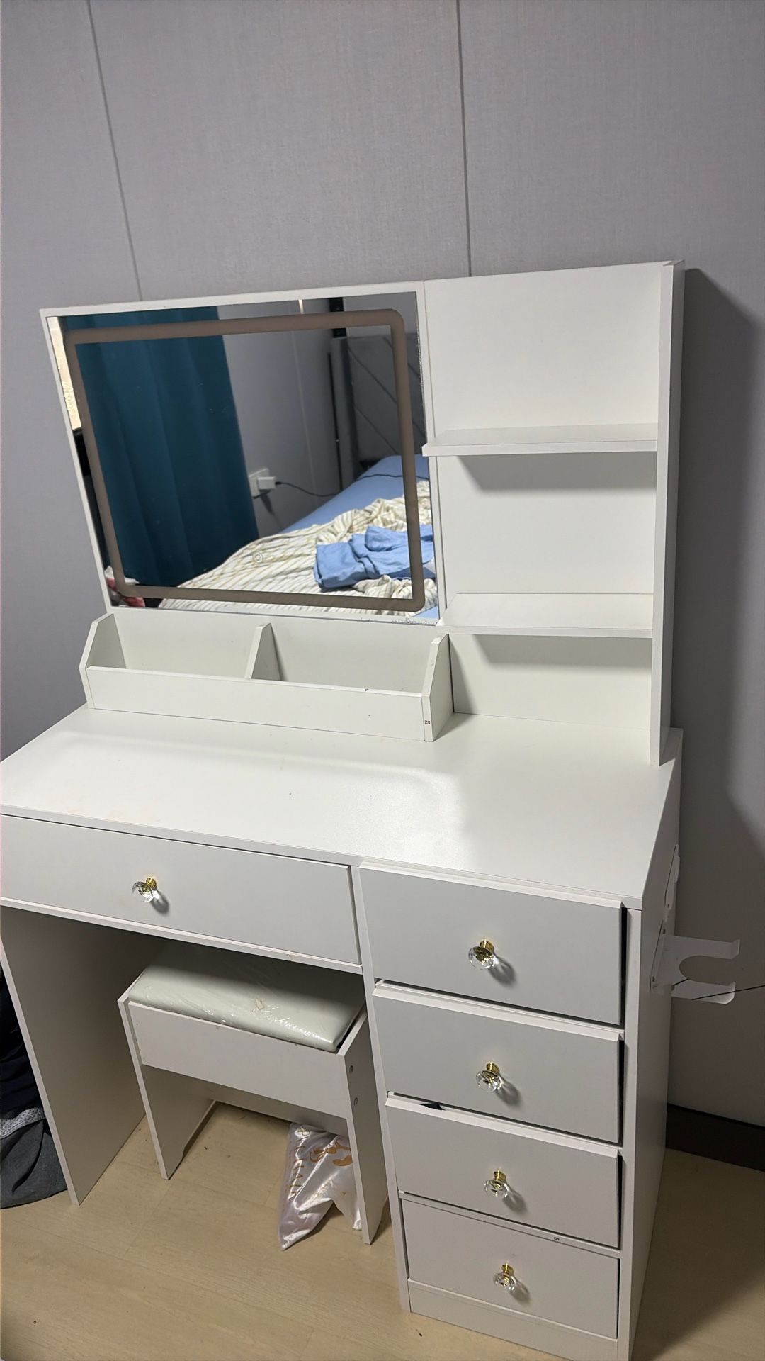 white vanity table with a mirror and drawers.
