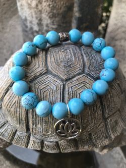 Turquoise stretch bracelet with lotus flower charm size 7.5 inches