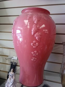 molded glass floor vase, potentially an American-made coral pink baluster-shaped piece featuring relief decoration with floral motifs. 