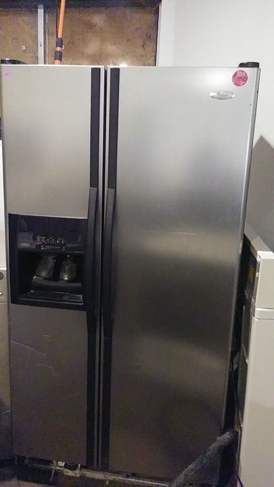 Whirlpool black and stainless steel side by side refrigerator
