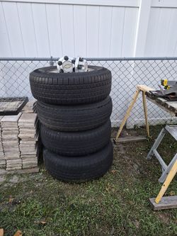 Tires and rims for a Chevy or GMC truck (275/70/R17). One tire is not in good condition, but the other three have about 80% tread life remaining.