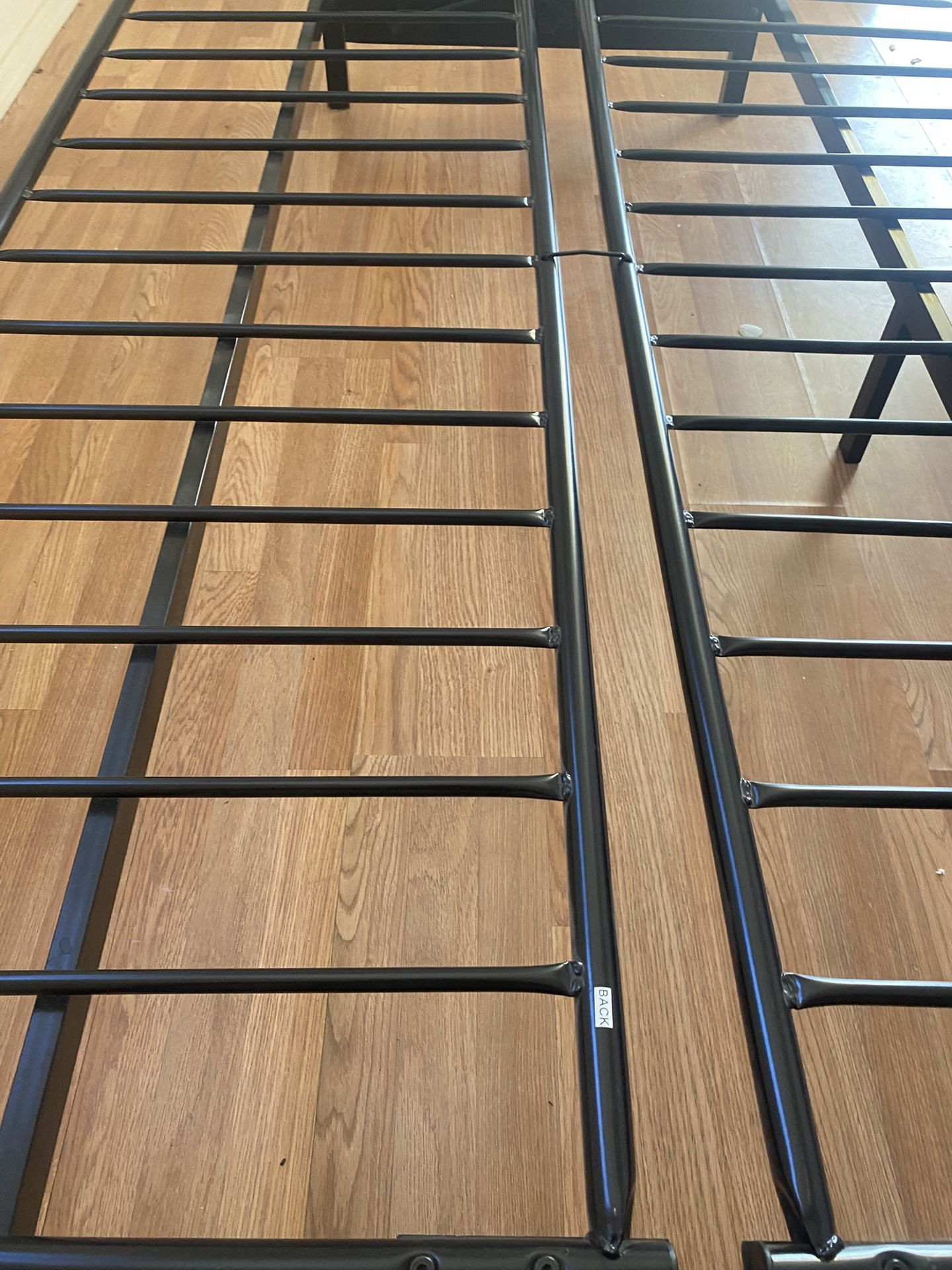 Futon base is of metal and the hand rests are of solid wood