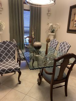 Glass and metal dining room table and 8 chairs