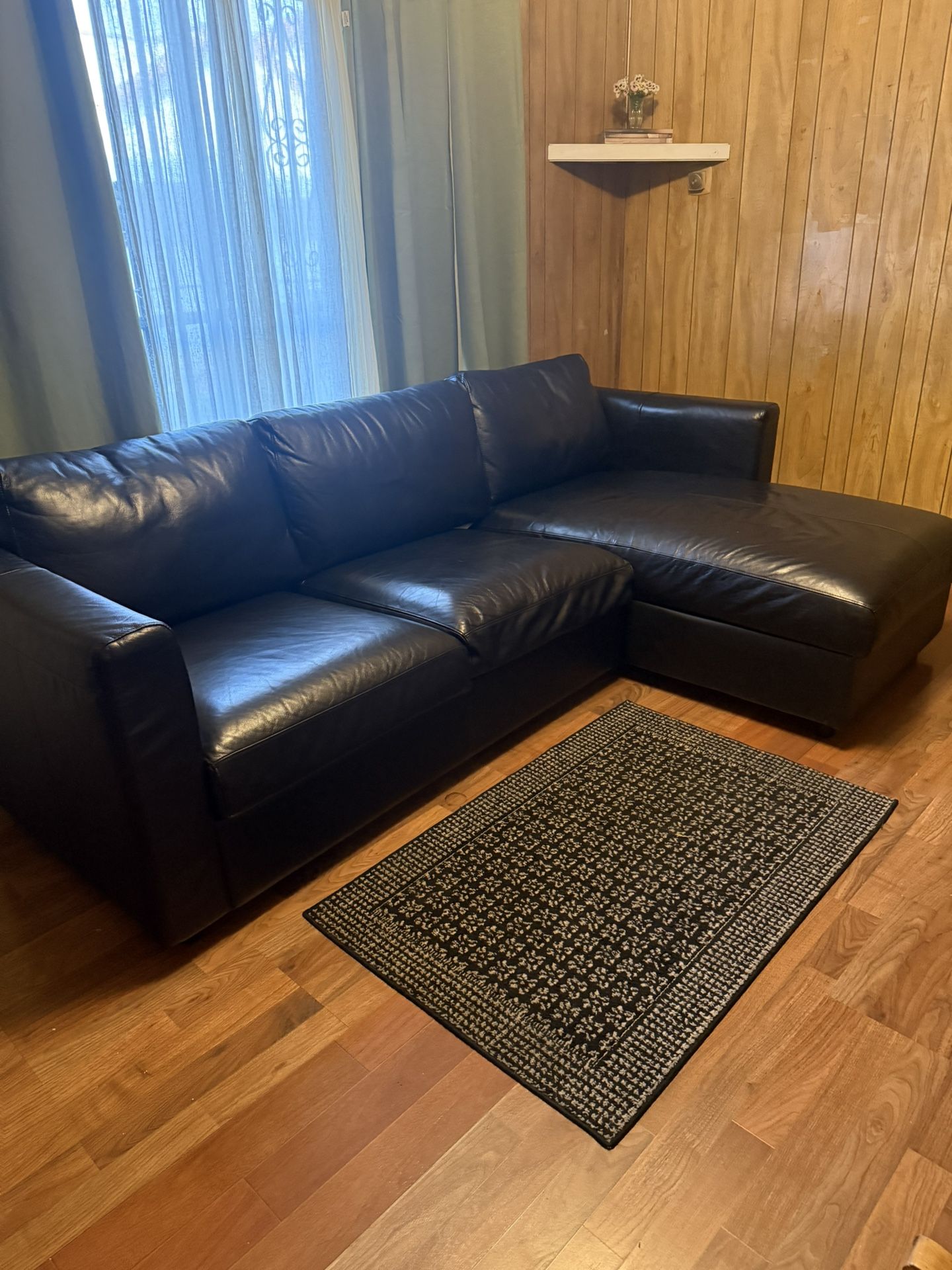 IKEA finnala black leather sofa with storage chaise