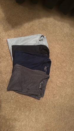 Size M men’s workout Under Armor shirts