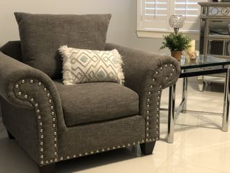 Elegant gray couch and glass side table