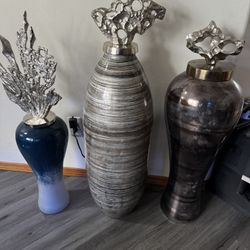 Three porcelain pots with silver tops. Used for decoration. Tall one is over 36 inches.
