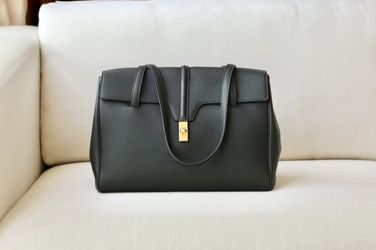 High-end, sophisticated leather tote with black gold trim, dimensions: 38 X 26 X 18cm


