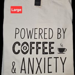 White t-shirt with 'Powered by Coffee & Anxiety' print.