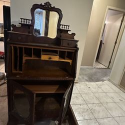This is an antique mahogany secretary desk with a hutch