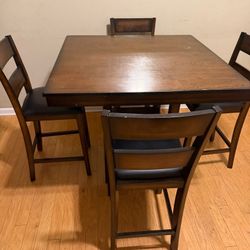 Dark brown counter height table and 4 chairs