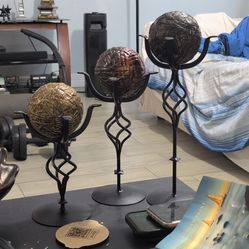 decorative iron candle holders with sphere accents.