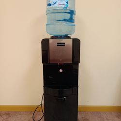 Water Dispenser Cooler and Heater With Storage in good condition very clean 5 gallon water bottle included 