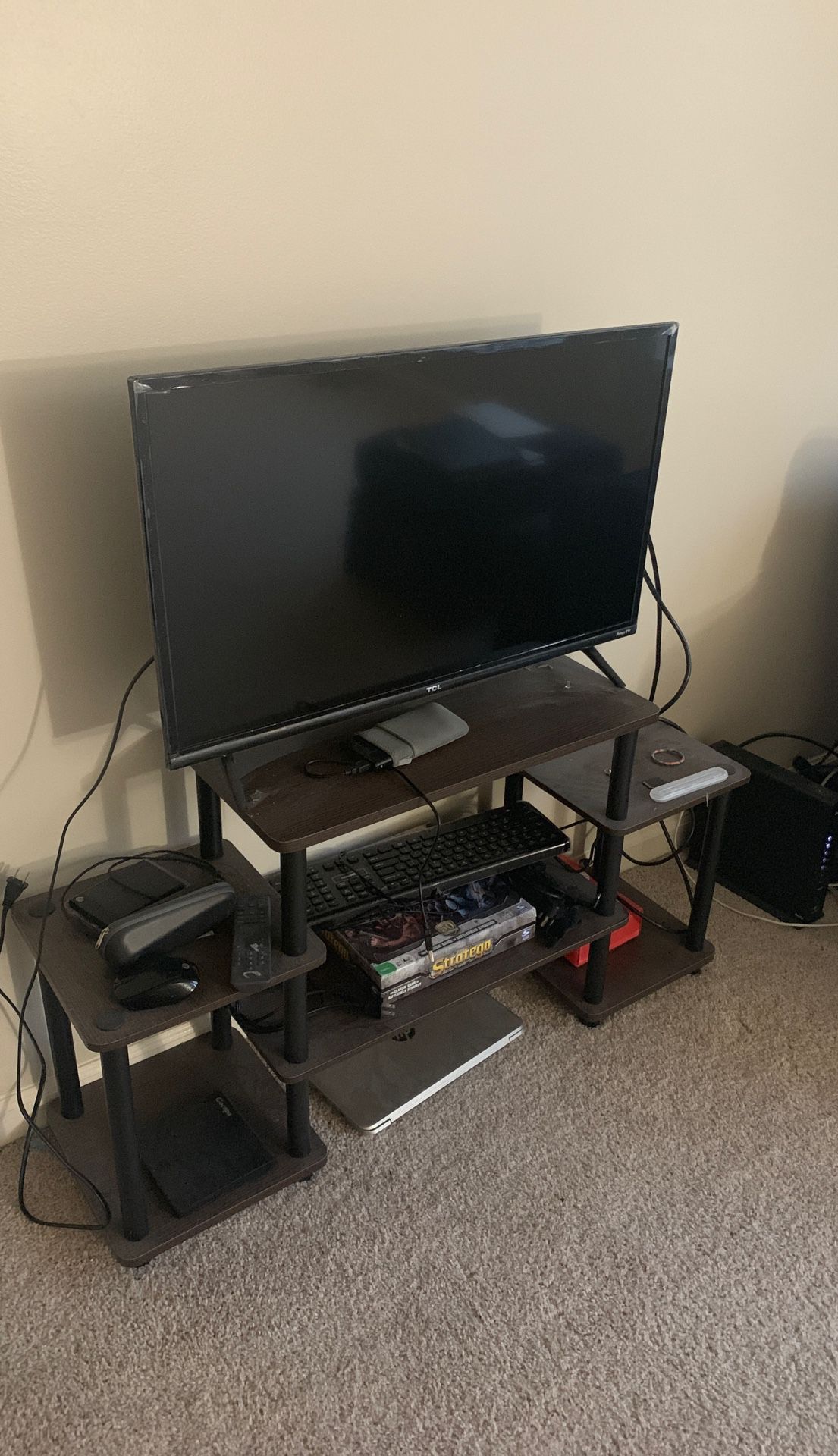 Selling TCL 32 inch 1080p Roku Smart LED TV. Along with it, comes dark brown detachable TV stand