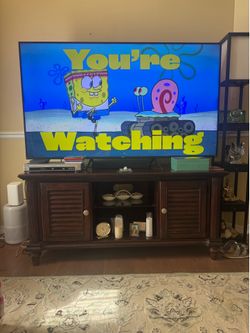 Tv Stand made of Solid Wood 24” deep x 30” high x 62 wide $350 OBO Some scuffs/patina…  (The TV Stand is pictured with a 75” TV which is NOT INCLUDED.