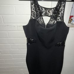 a black, form-fitting mini dress by Guess