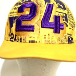  Kobe Bryant #24 Los Angeles Lakers snapback hat, manufactured by the brand Top Level. It features the iconic Lakers yellow and purple colors. 