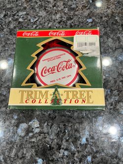 Vintage 1990 Coca Cola Bottle Cap Christmas Ornament . Size 2 3/4 inches Wide . Brand New In Original Packaging. Brand Trim a Tree Collection.