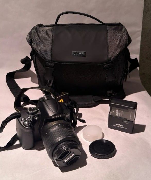 Nikon D5000 with 18-55mm lens charger battery 8gb card and case.