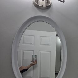 Three white, oval bathroom mirrors