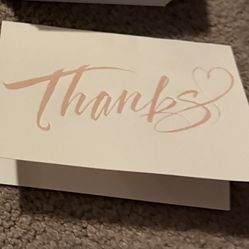 folded note card with the word "Thanks" written in elegant script on the front