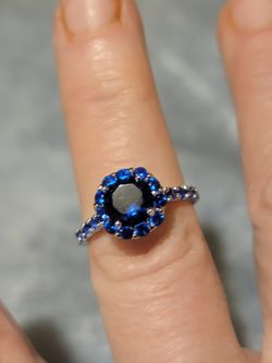 Beautiful Solid 925 Silver With Rhodium Plating Ring With Natural Blue Sapphires All Around It And Down Each Side. Size 6.