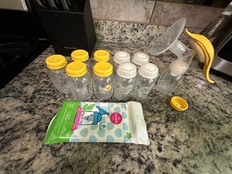 Medela hand pump and storage bottles.