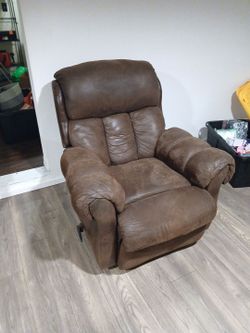 Brown swayed leather recliner chair