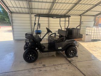 Black Lifted Golf Cart with Rear Cargo Bed