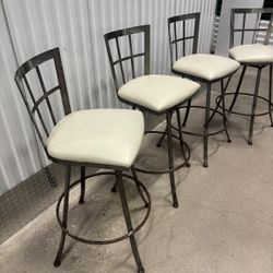 Solid steel stools with leather seats and they all swirl  30 “ high to seat … $100 for all
