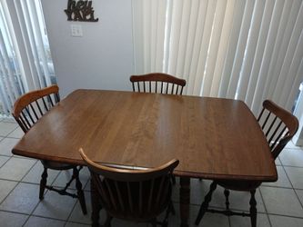 Wood dining room table with four chairs