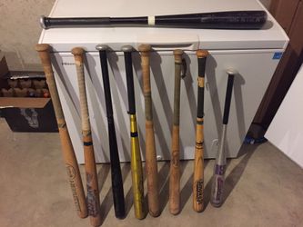 Softball bats and 1 baseball bat